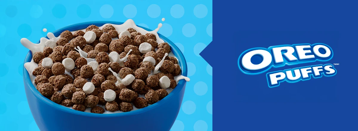 Oreo Puffs cereal in a bowl with milk splashing